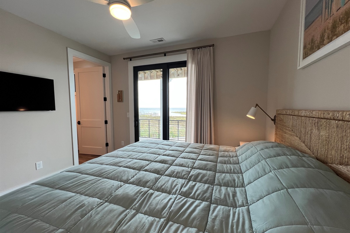 Wheelchair accessible king bedroom ensuite. West King bedroom with ensuite and door to deck with hot tub.