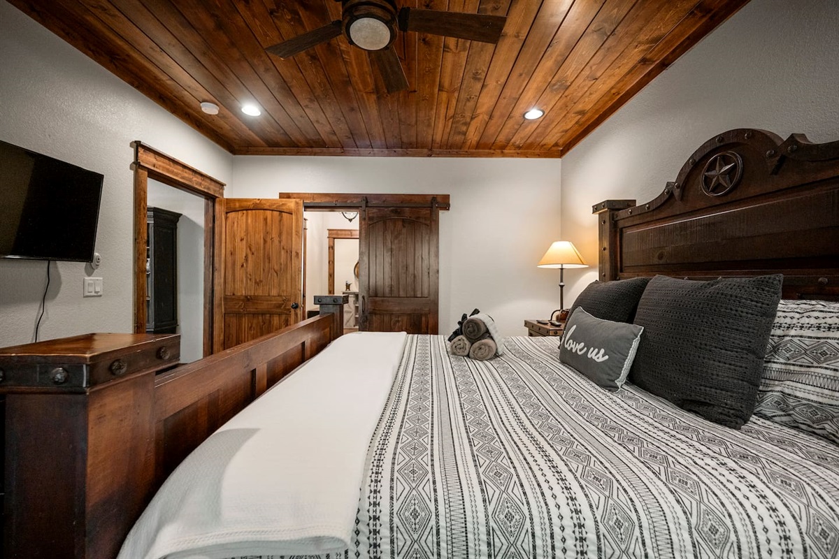 A comfortable bed, ceiling fan and black out curtains for a good night's rest