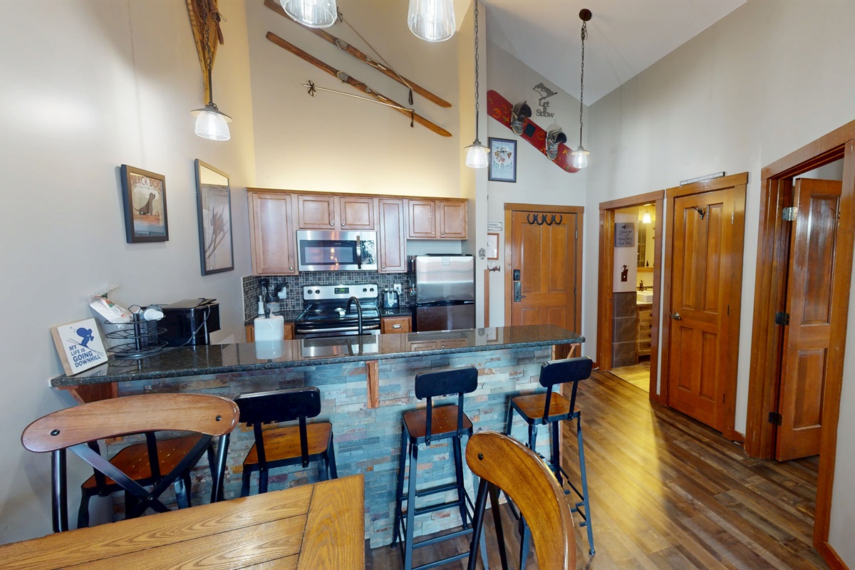 Modern kitchen with granite countertops and stainless appliances — everything you need for a mountain feast.