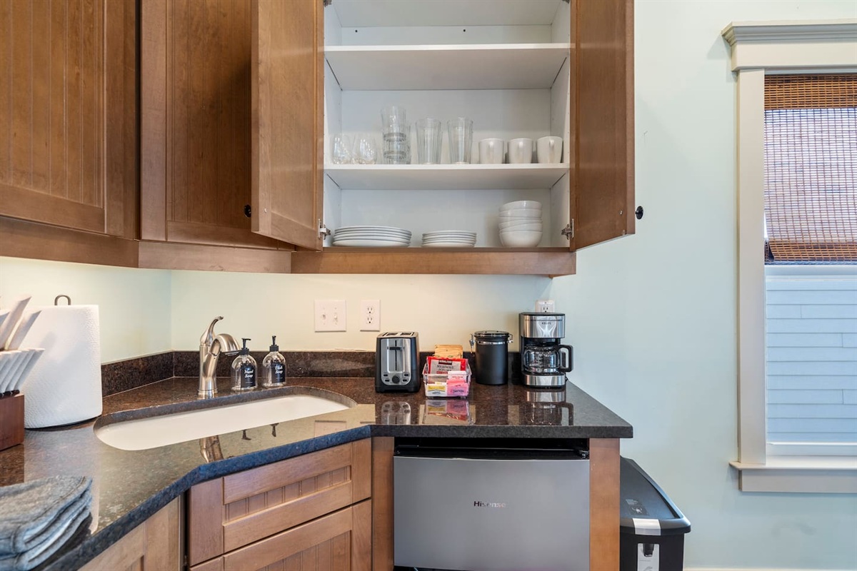 Fully stocked kitchen counter — small appliances, cookware, and complimentary coffee waiting for you