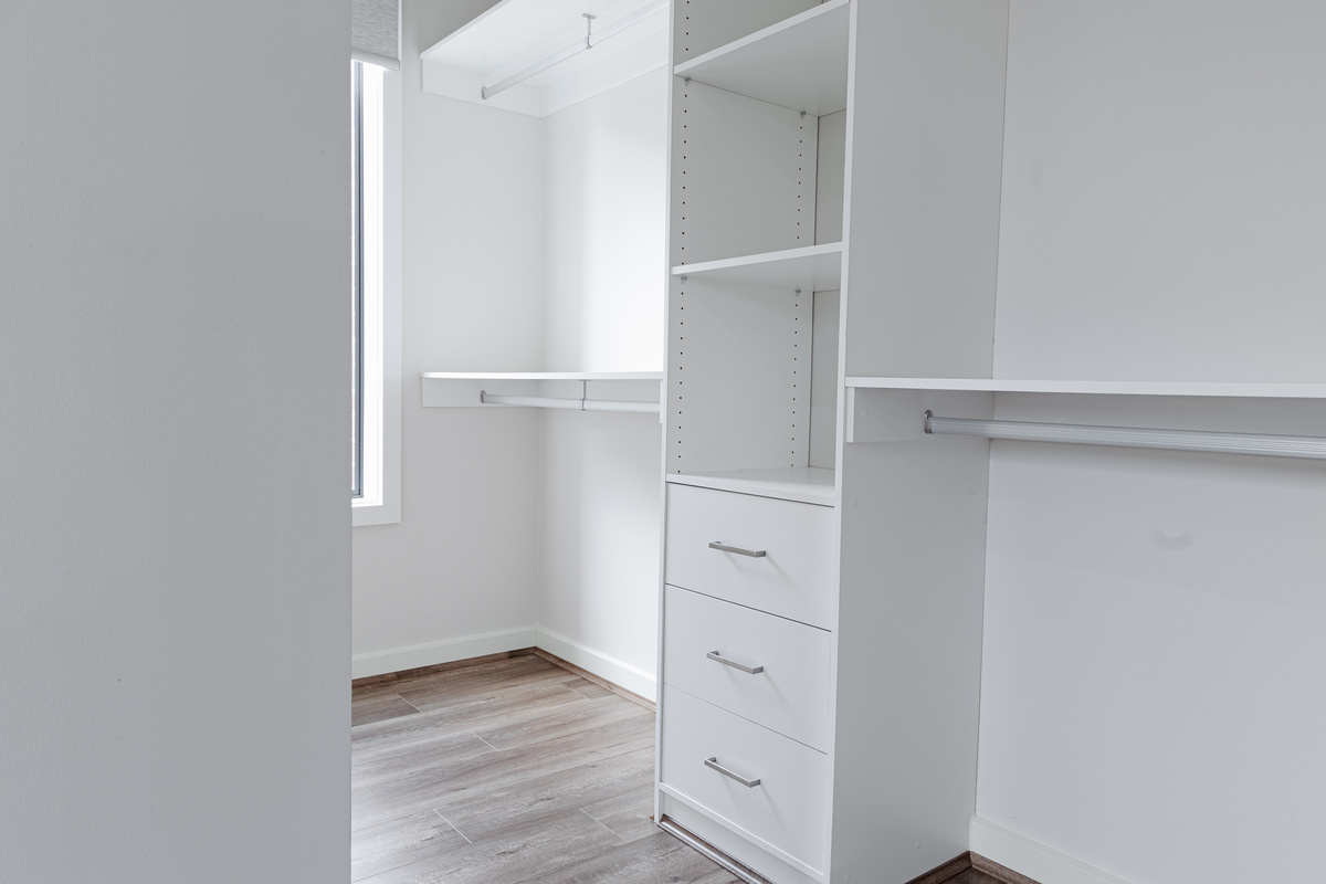 The walk-in robe at Willows Stays Holiday adds useful storage to the bedroom layout, with hanging rails, shelving and drawers for longer stays.