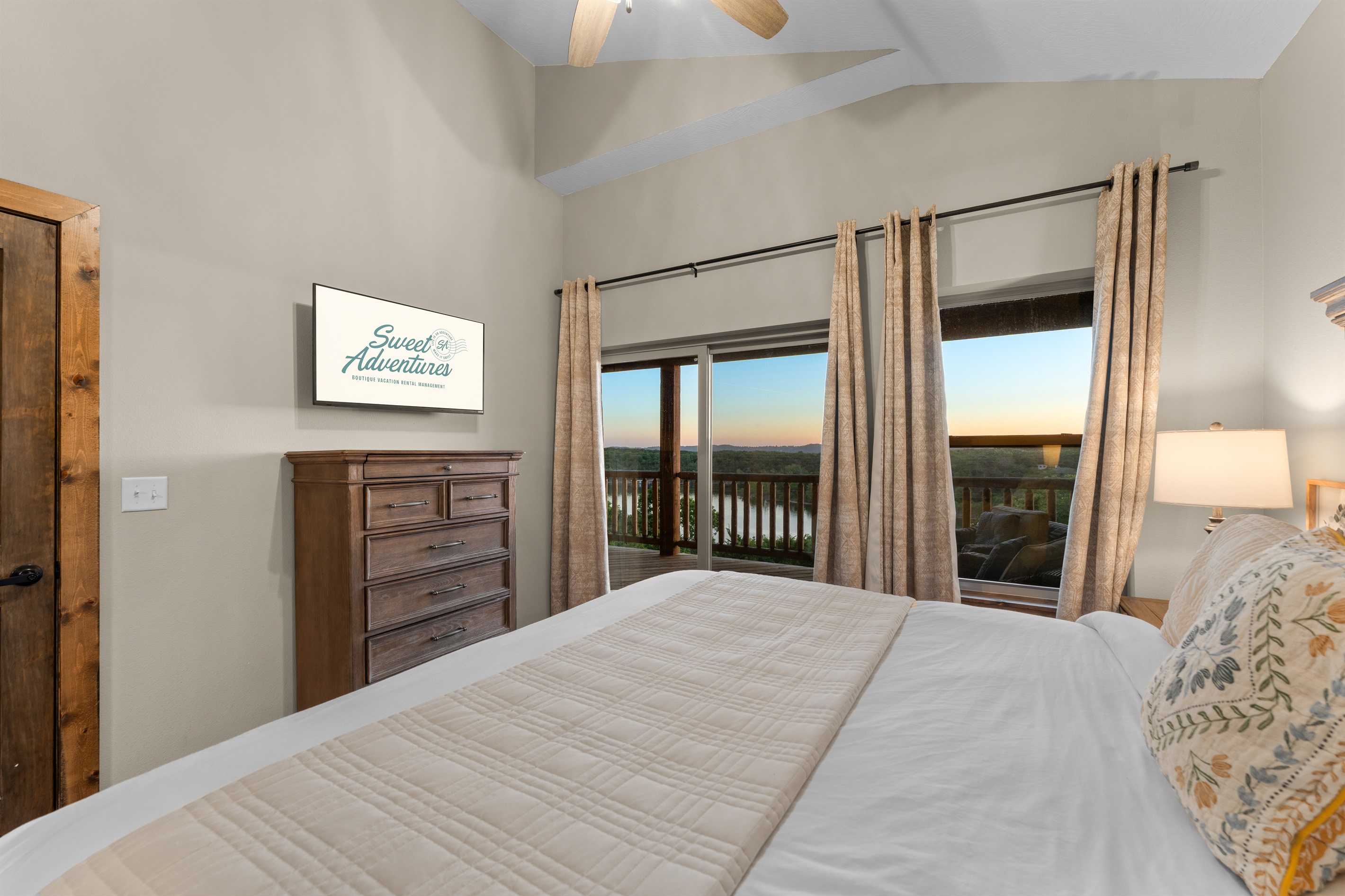 Upstairs king bedroom with sunset views and access to the upper deck.