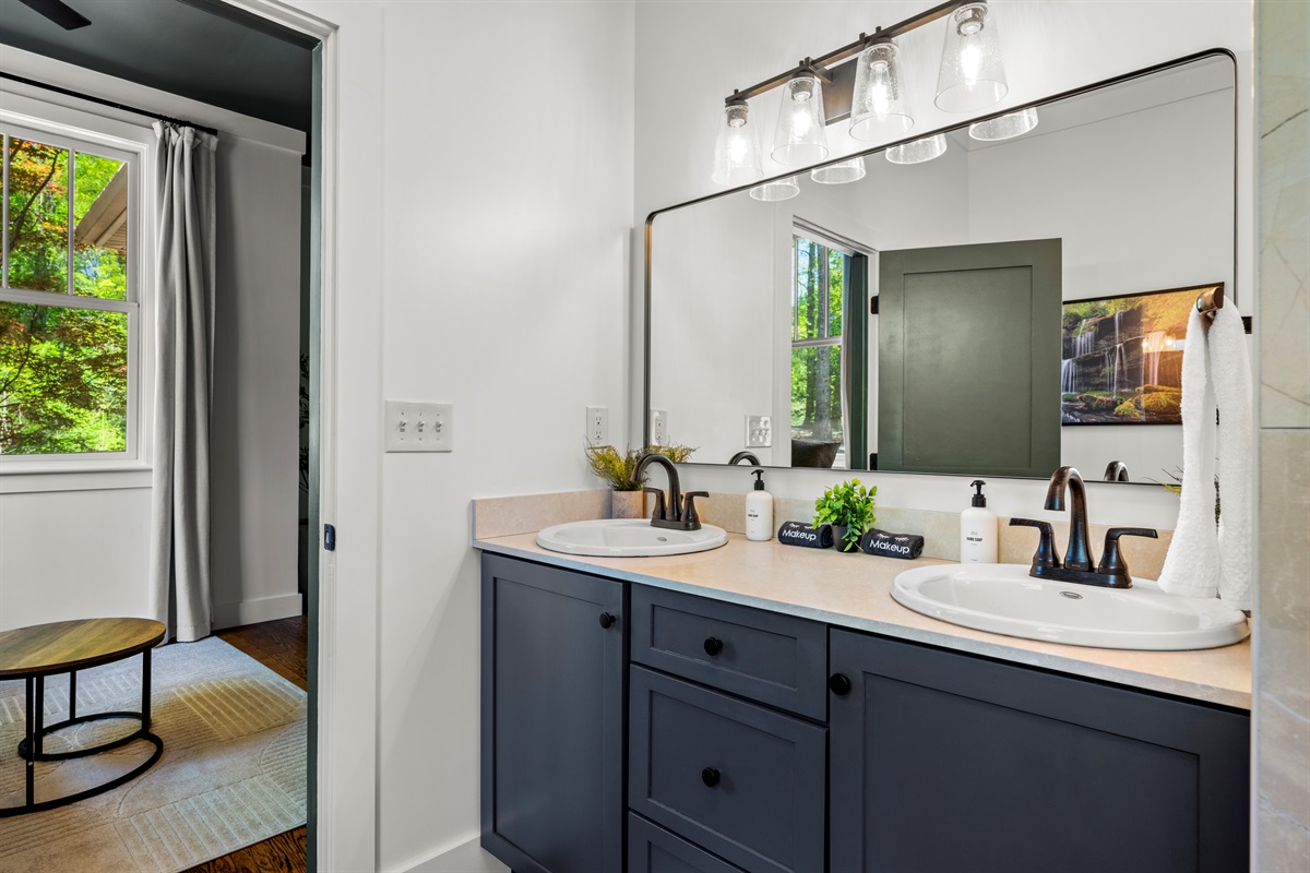 Getting ready is easy with dual sinks, soft lighting, and plenty of counter space—perfect for couples or families sharing the master ensuite.