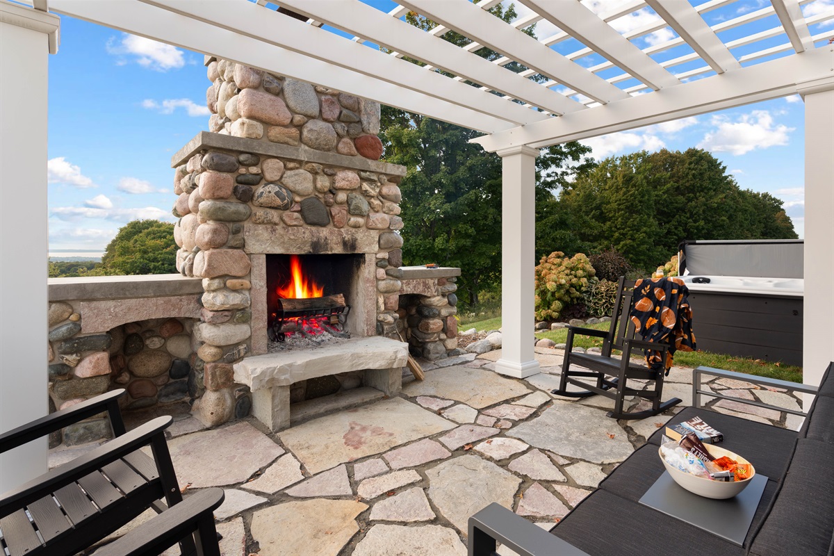 Enjoy lounging by the outdoor fireplace in the bonus outdoor living area, then spend some time in the hot tub as you enjoy the most incredible views of Torch Lake and Lake Michigan, 