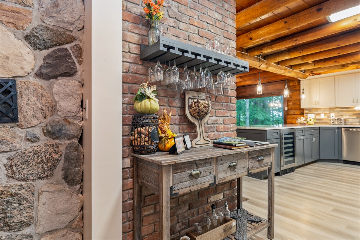 Gather around the stunning brick hearth, complete with rustic décor and a built-in bar area for entertaining.
