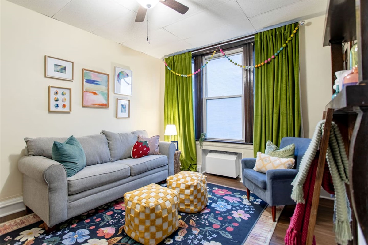 Bright and spacious living room featuring a comfortable sofa bed, perfect for relaxing or accommodating extra guests.