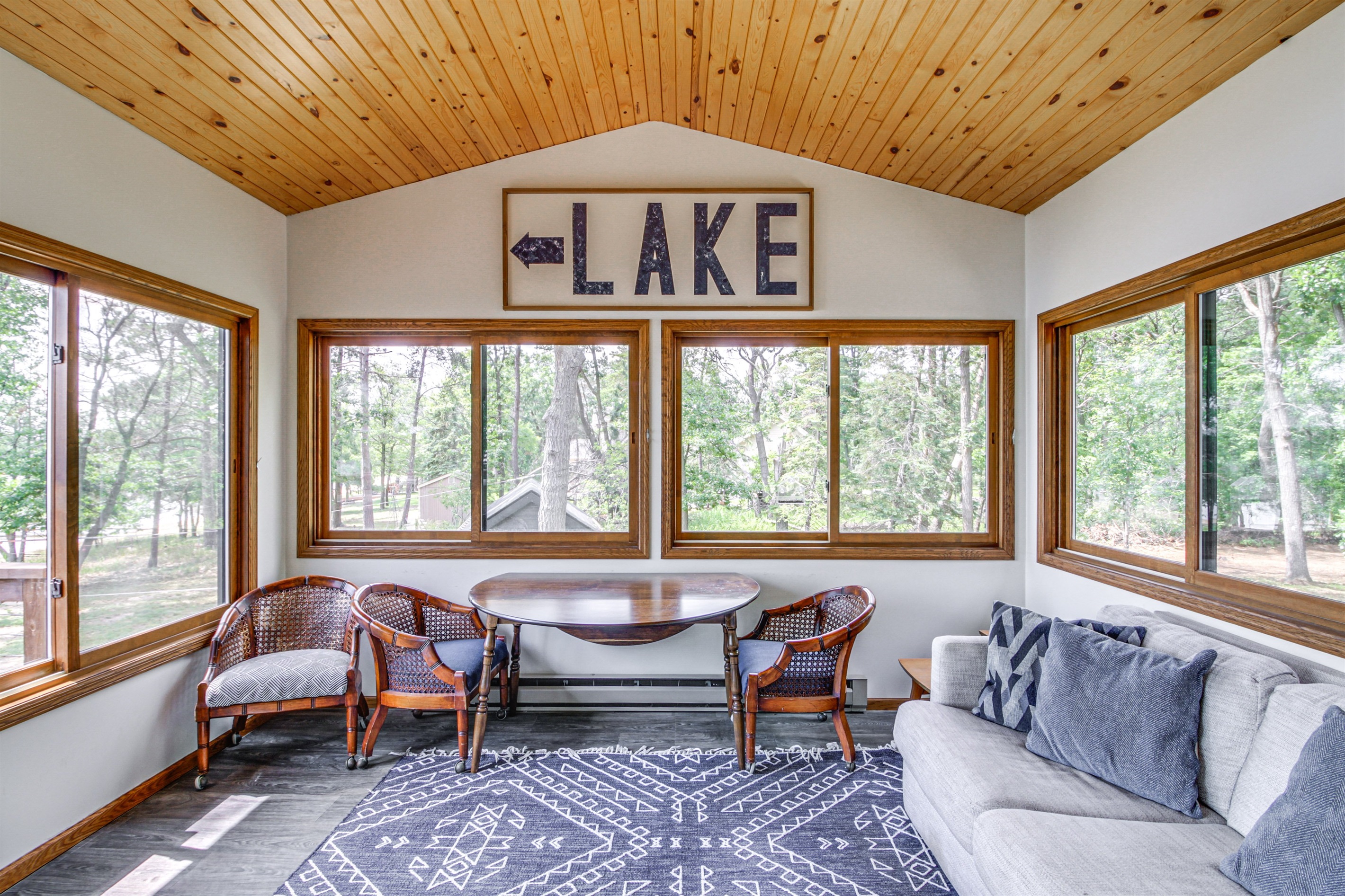 Cozy sunroom with lake-themed décor and seating for games, coffee, or quiet time