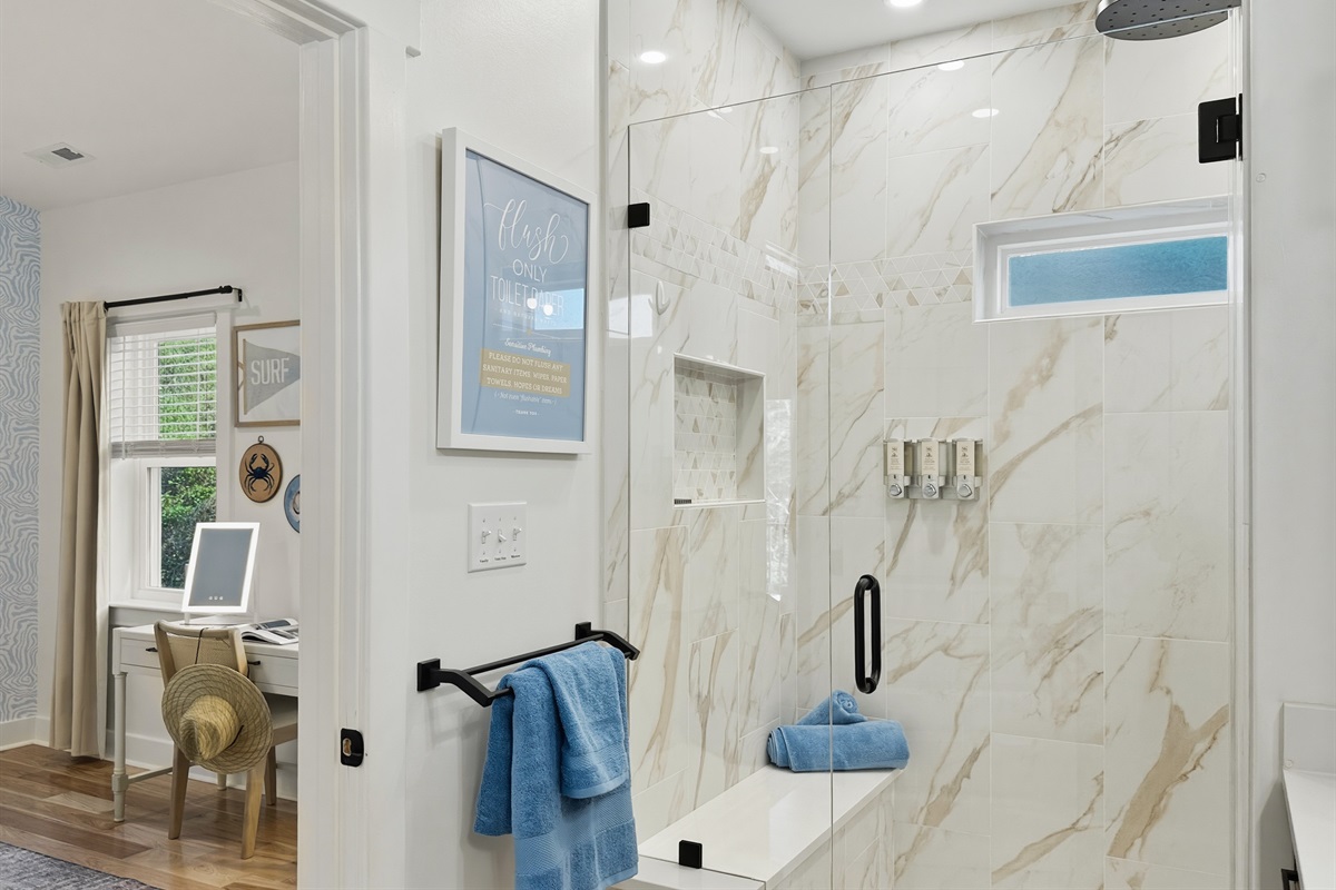 The deluxe en-suite bathroom has a rainfall shower.