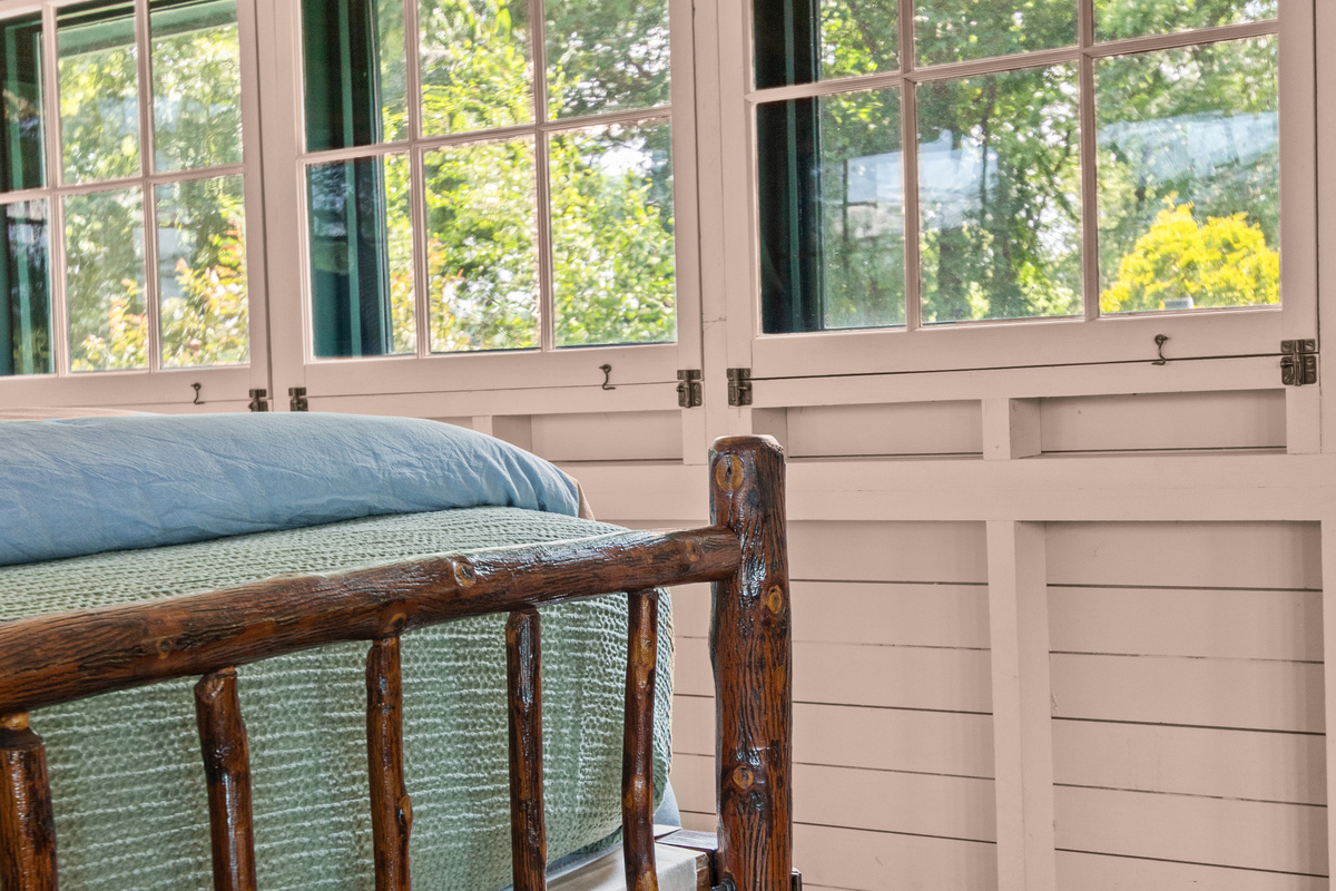 Warm wood finishes and vintage touches create a cozy retreat full of timeless lake-house character.