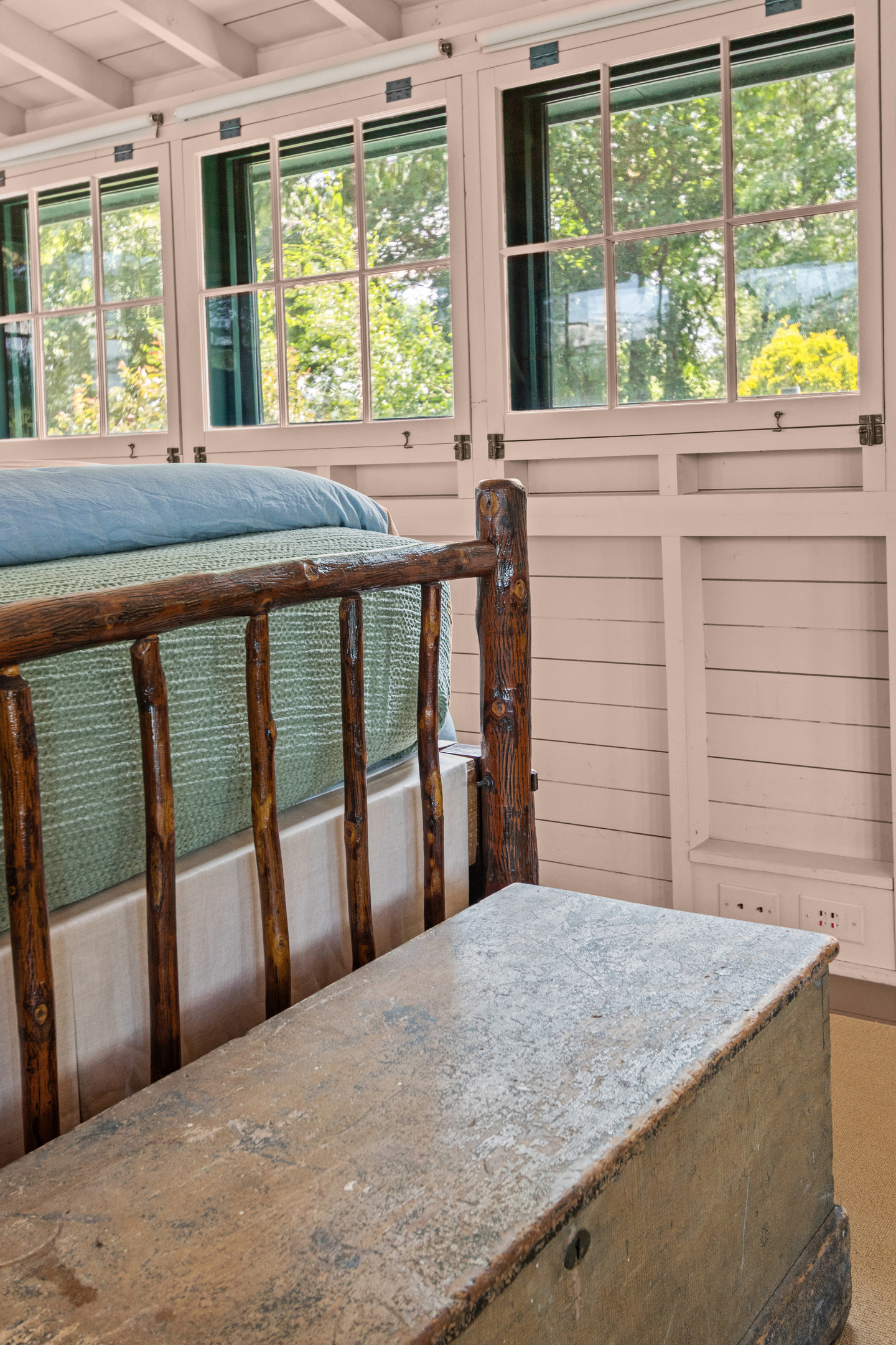 Warm wood finishes and vintage touches create a cozy retreat full of timeless lake-house character.