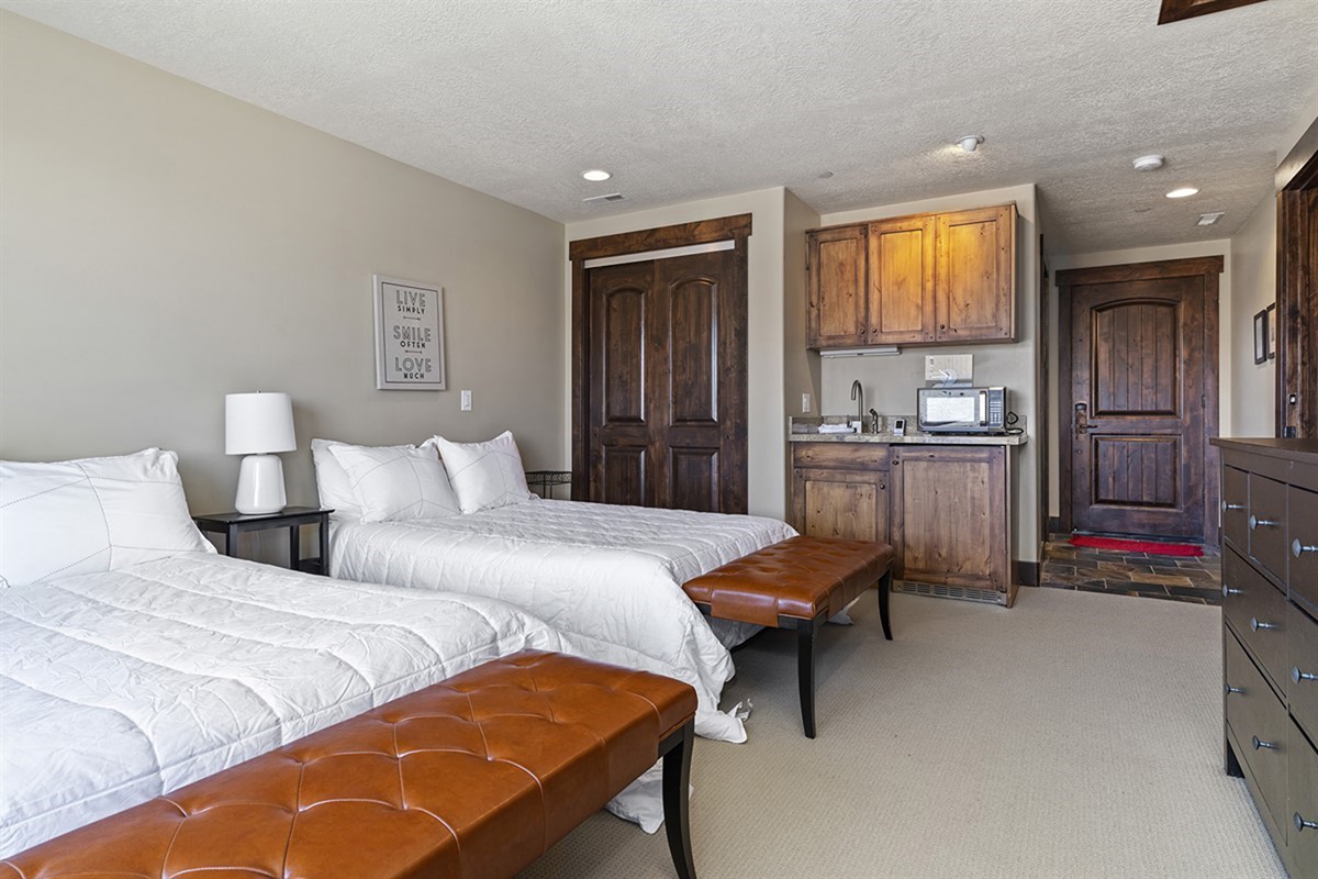 Generously sized and well-appointed, this bedroom provides a welcoming retreat complete with seating and refined details.