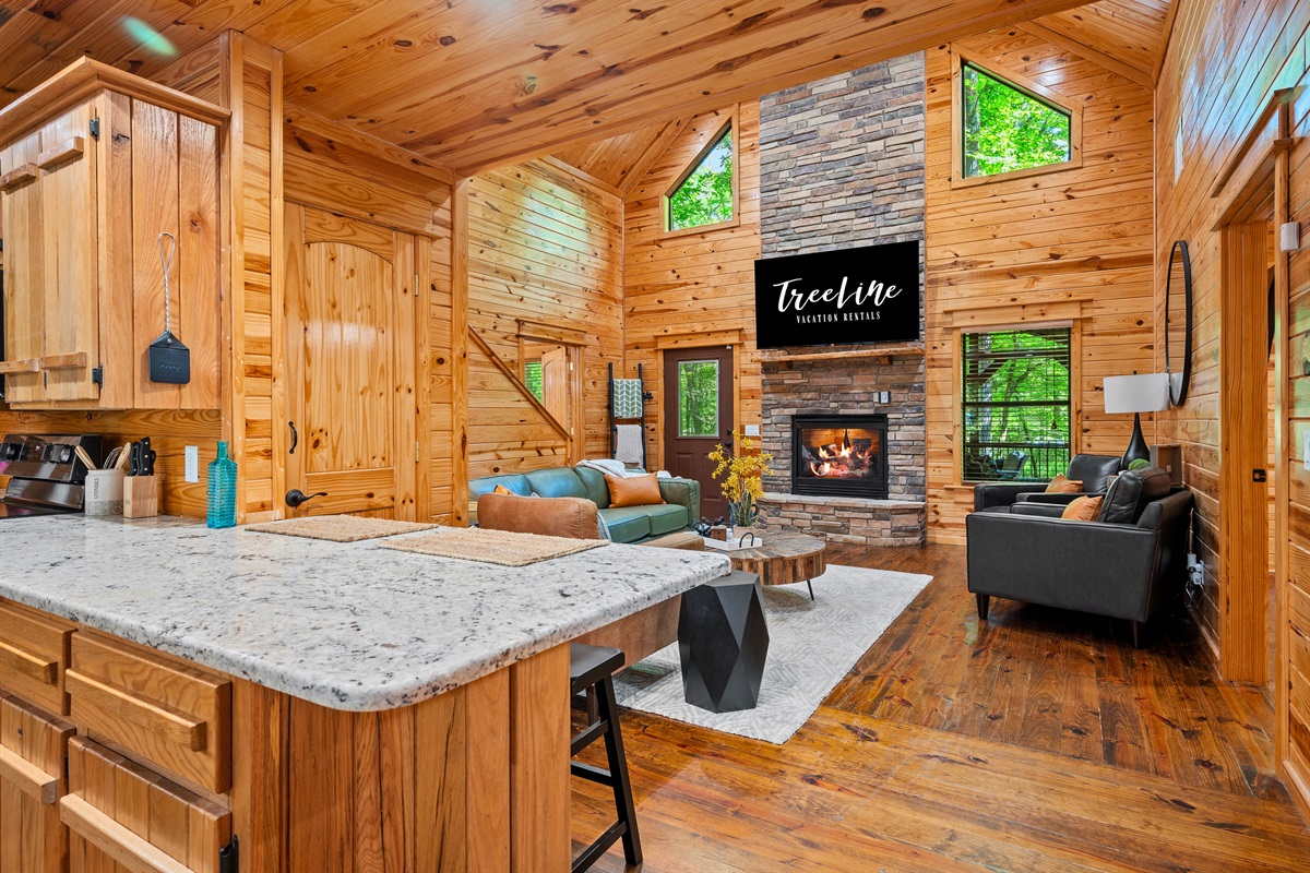 Bright, open-concept kitchen and living room combo with seamless flow and inviting rustic charm.