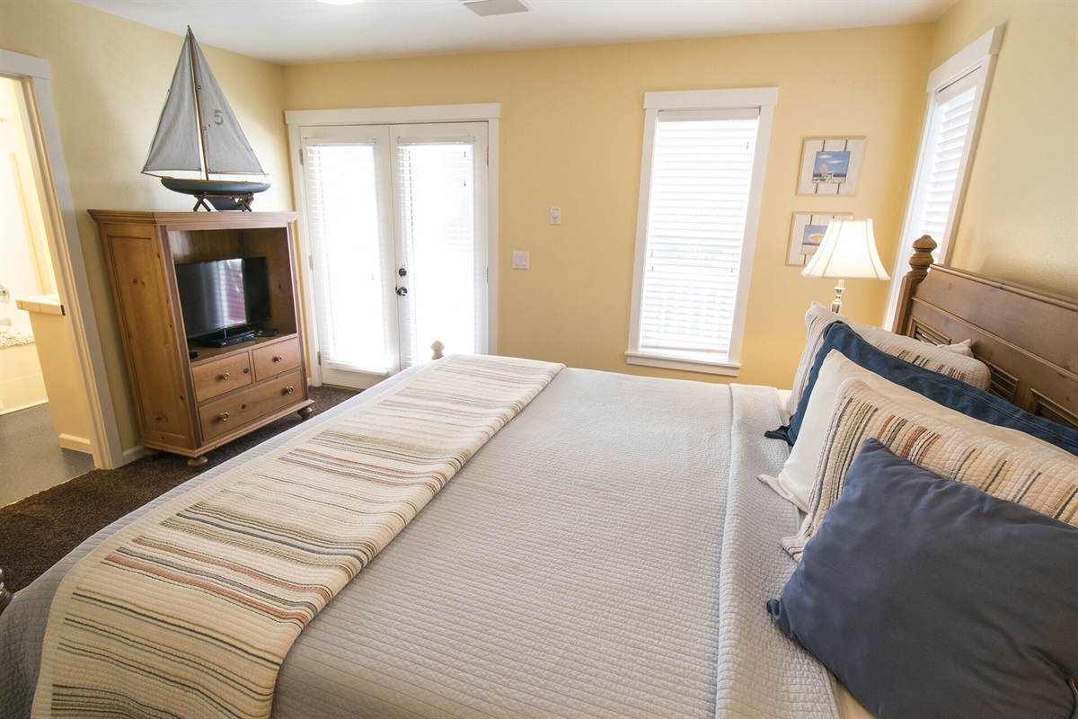 Wake up in the master suite with a king bed and step out onto your private deck to enjoy fresh coastal air.