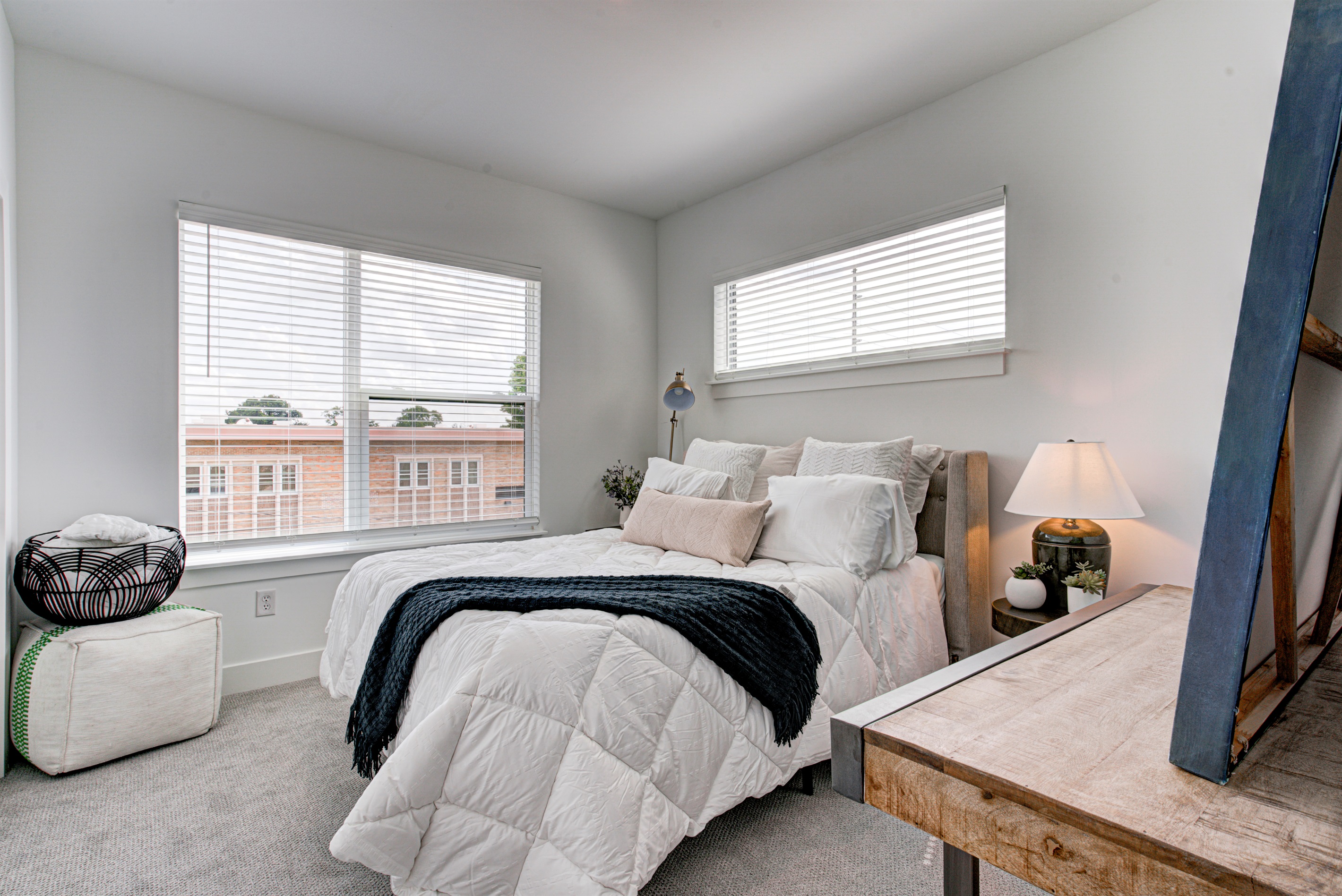 Relax in the serene master bedroom featuring a comfortable king-size bed, soft linens, and cozy pillows. Includes nightstands, lamps, walk-in closet, and full-length mirror for added comfort. 