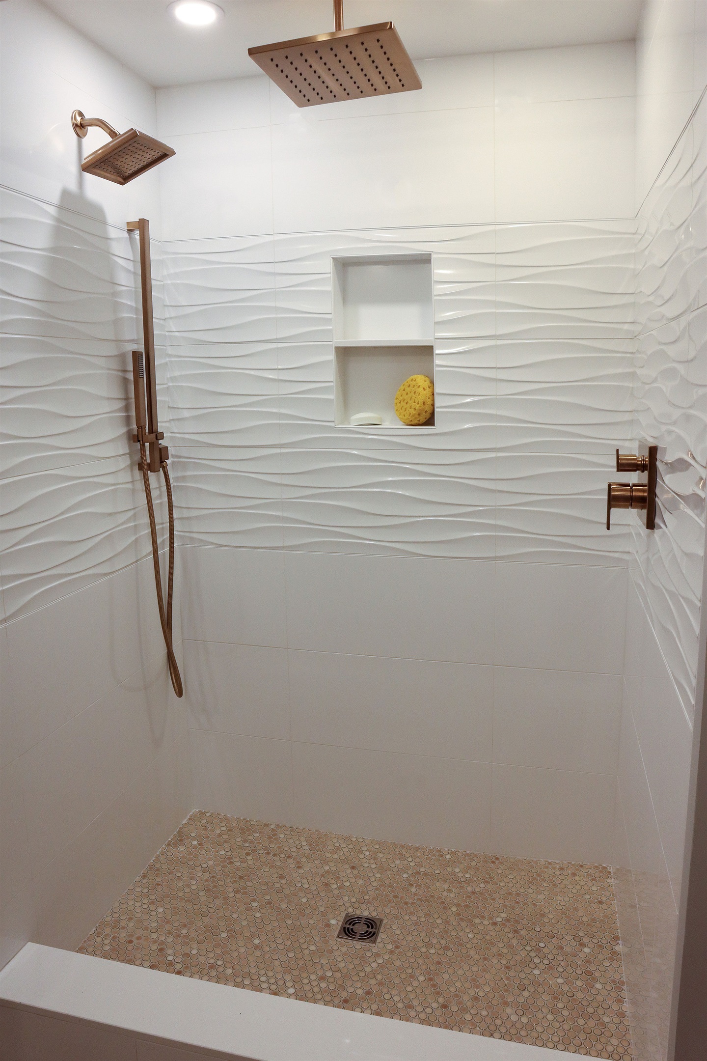 This bathroom features a rainfall shower head, a hand shower, and a standard shower head for an ultimate spa like experience 