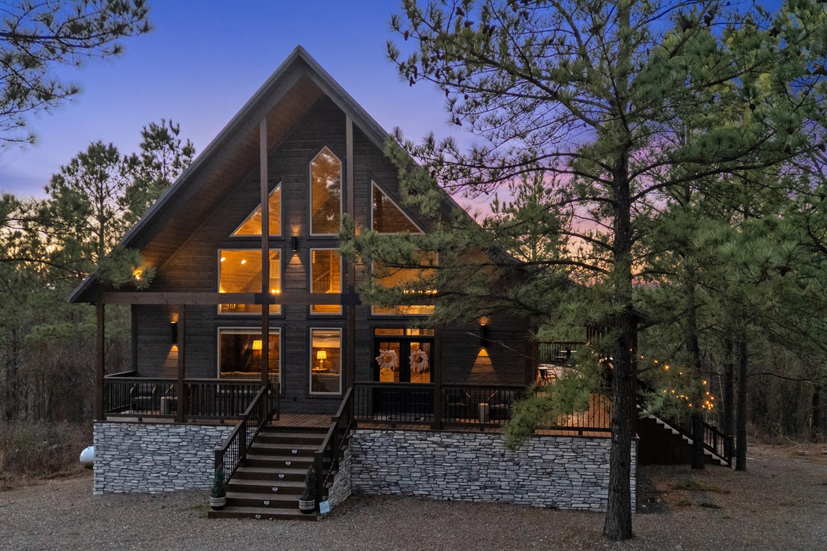 A front view like this highlights the cabin’s rustic charm and the quiet setting that makes it feel like a true retreat.