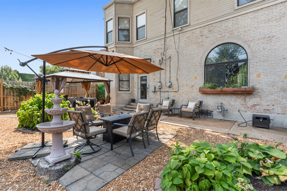 Morning coffee, dinner outside or cocktails under the umbrella - this backyard is made for lingering.