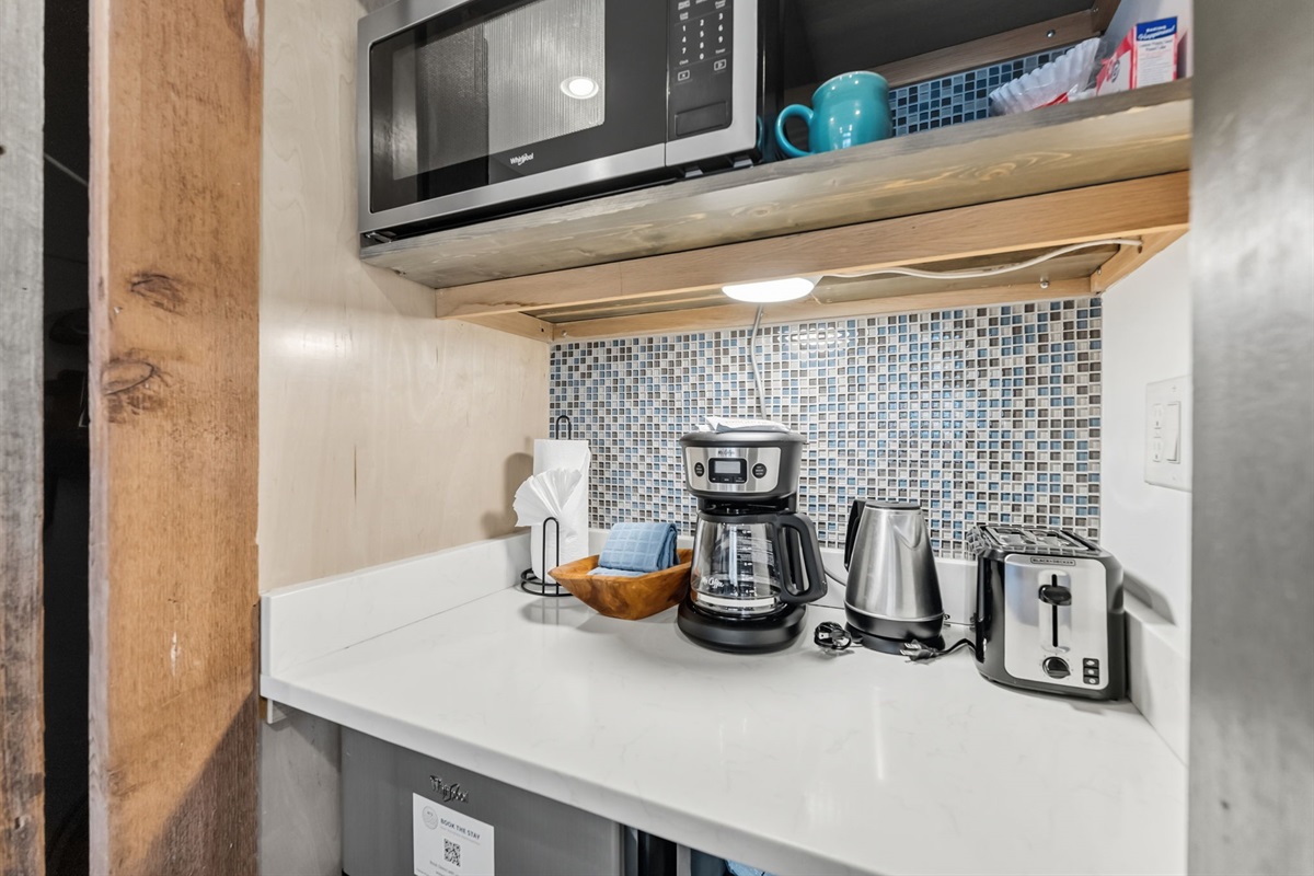 Closet and kitchenette with microwave, coffee maker and mini fridge