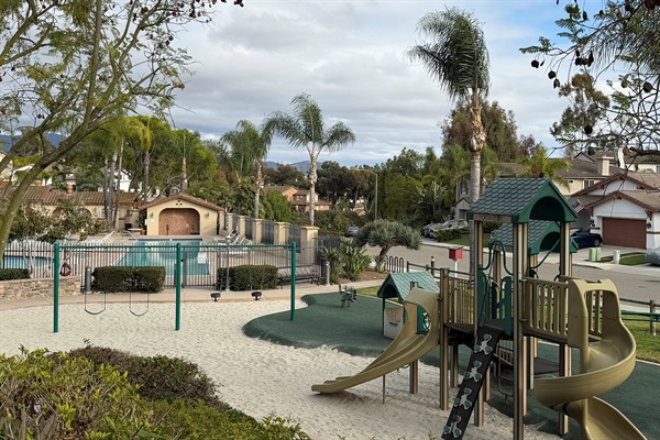 Nearby playground and park area for families