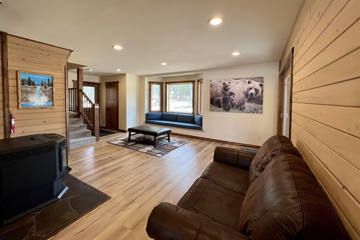 Living room off of kitchen with pellet stove and reading nook