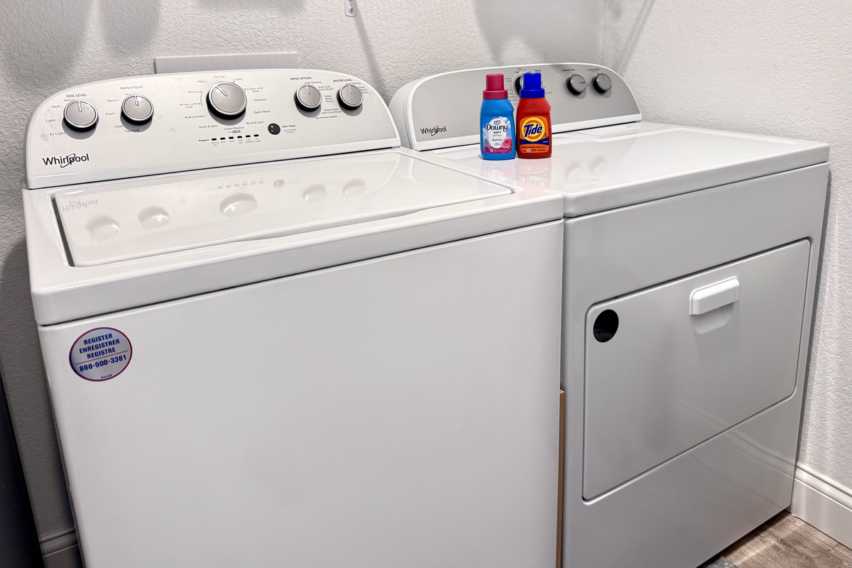 Washer and dryer with laudry soap, fabric softener, and dryer sheets.
