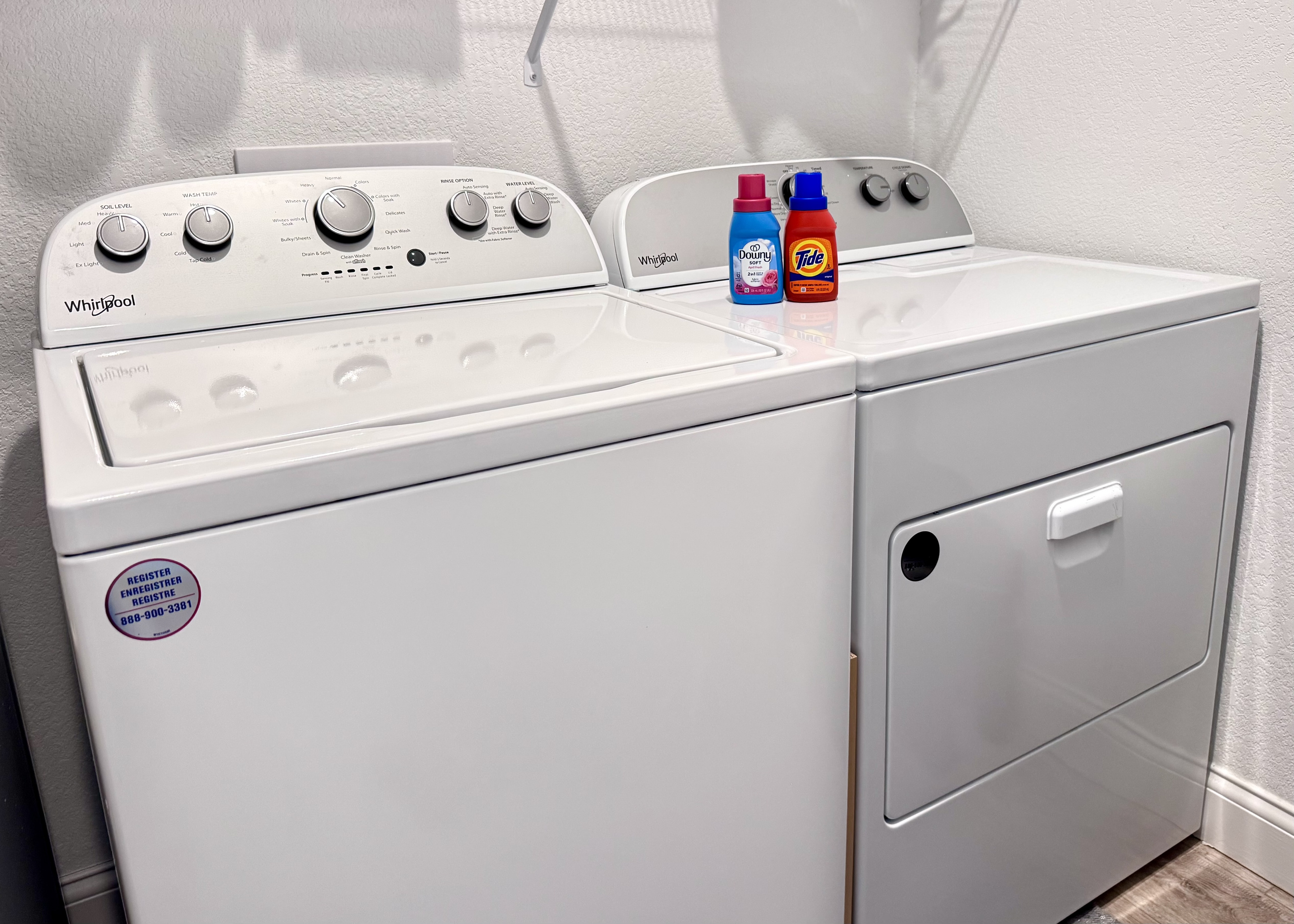 Washer and dryer with laudry soap, fabric softener, and dryer sheets.