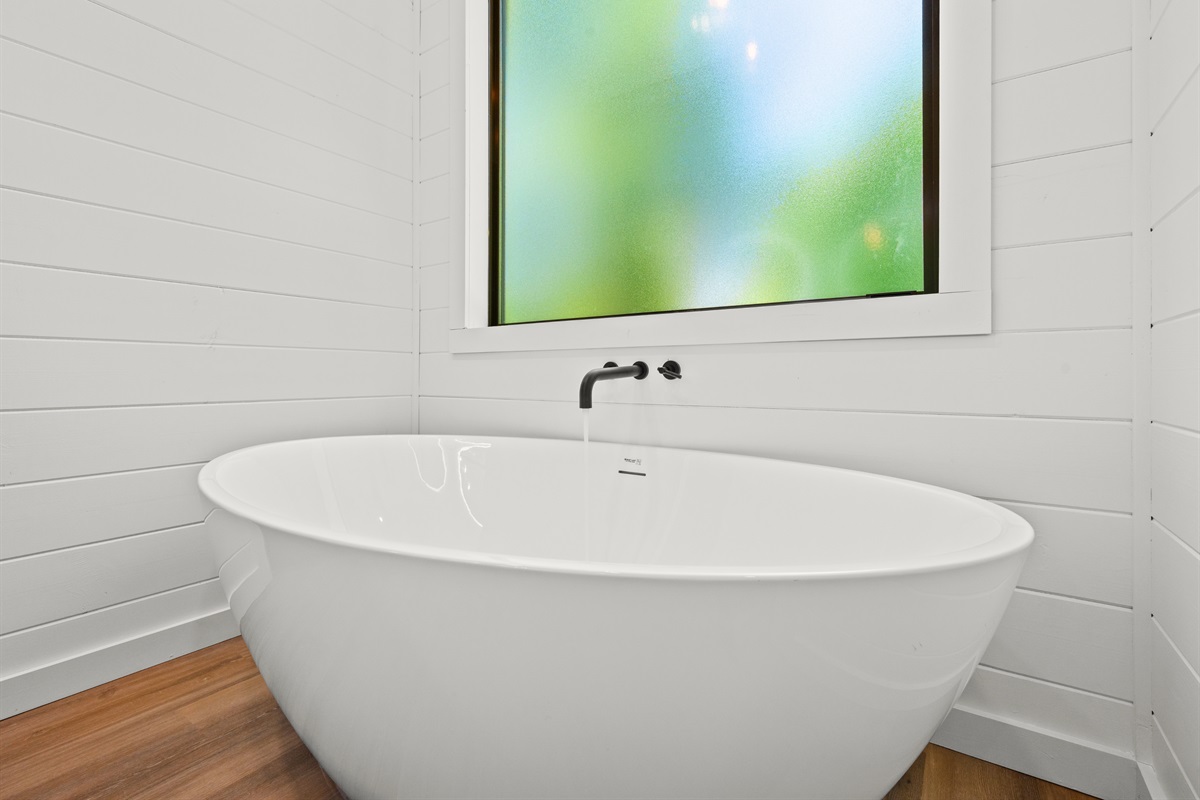 The freestanding soaking tub creates a spa-like experience where you can unwind after hiking trails, lake days, or evenings around the fire pit.