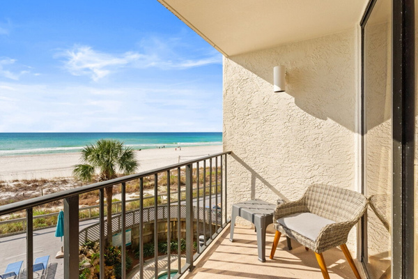 Private balcony overlooking the pool and beach