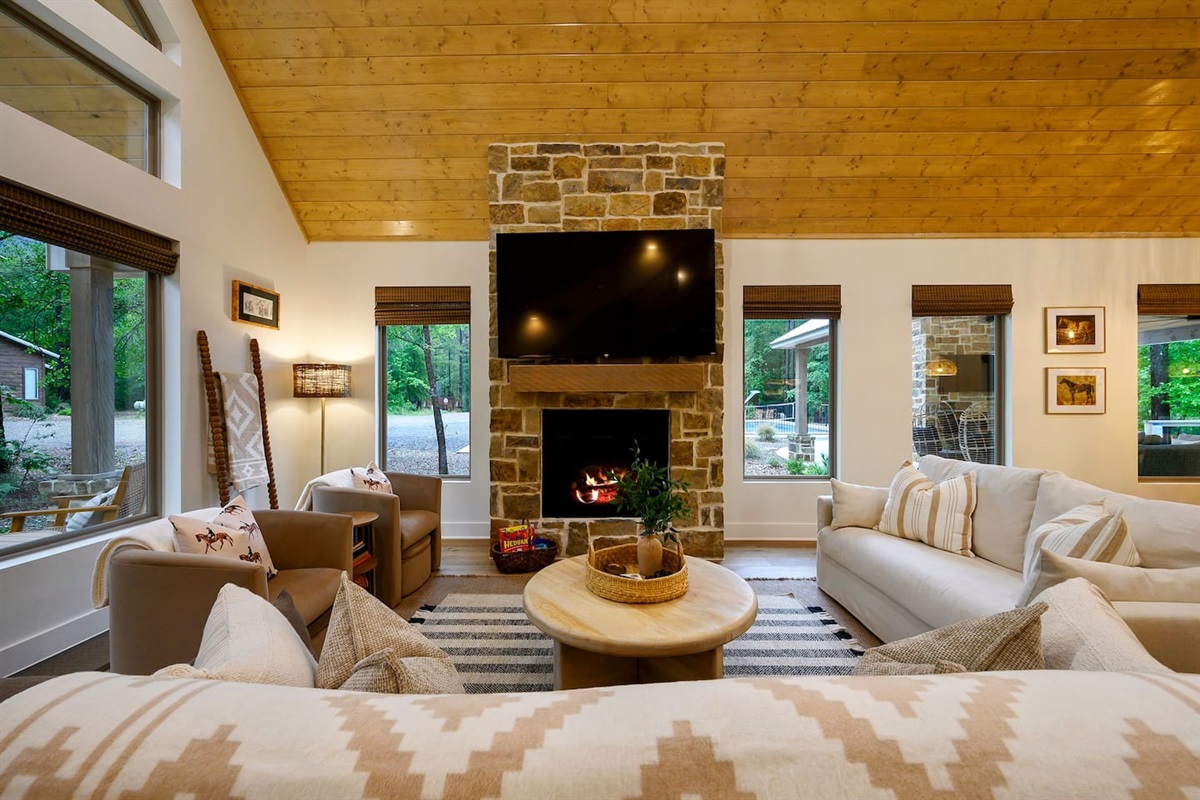A cozy focal point with timeless charm — the handcrafted stone fireplace anchors the living room, inviting you to relax and take in the warmth and beauty of this thoughtfully designed space.