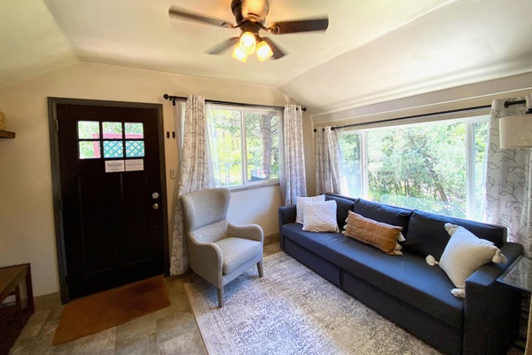Sunroom located off the front door.  The couch folds out to a queen size bed.  Close the doors and curtains for complete sleeping privacy.