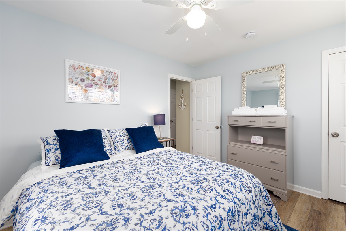 A well-lit 2nd bedroom, featuring a Queen-size bed, inviting d&eacute;cor, and ample natural light