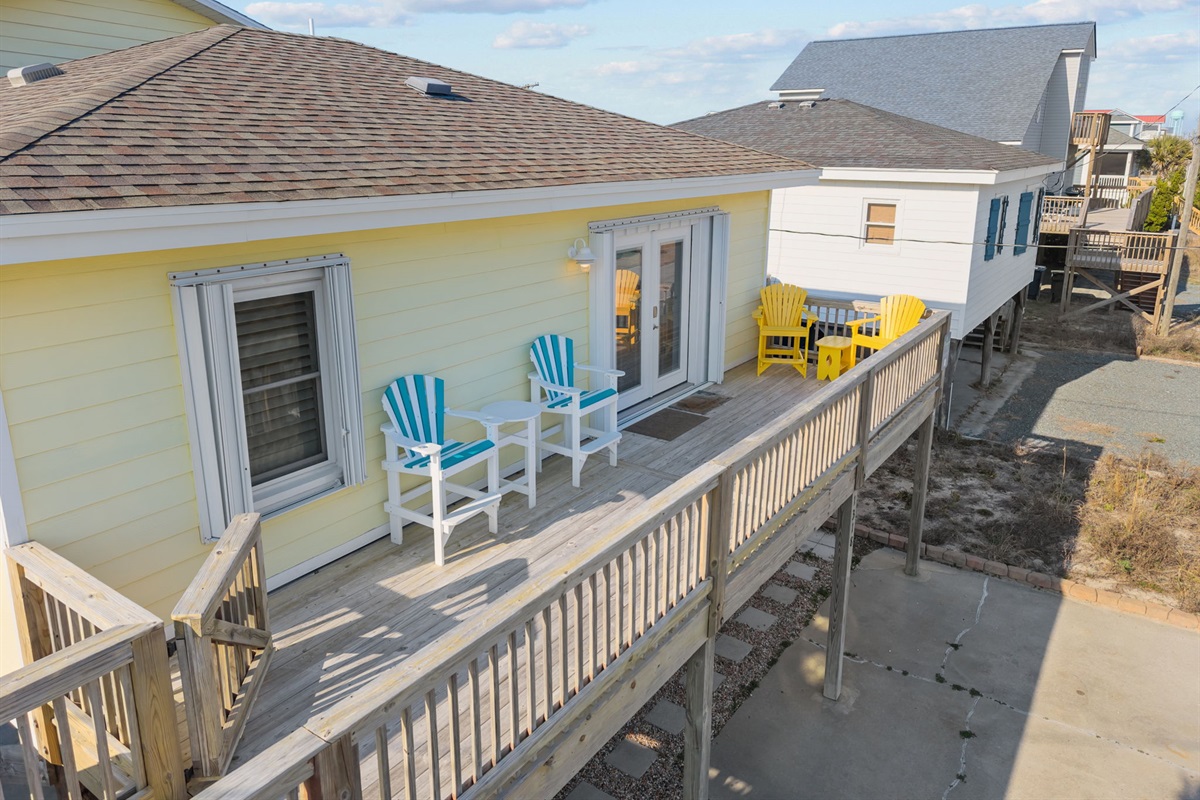 Elevated balcony with multiple seating areas, perfect for relaxing and enjoying ocean breezes