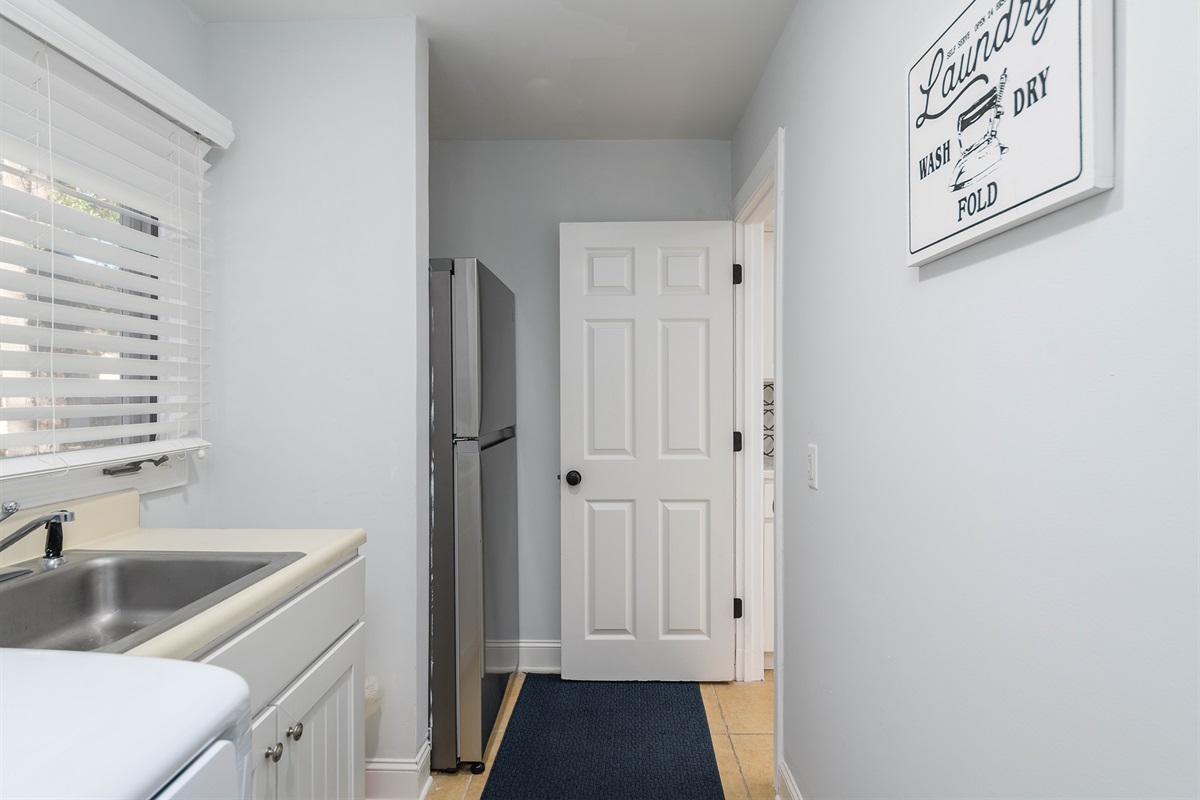 Laundry room off the kitchen features a second bedroomond