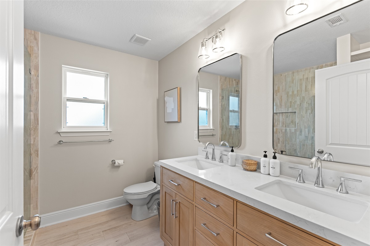 Primary bathroom that is fully renovated and offers double vanities and a walk in shower!
