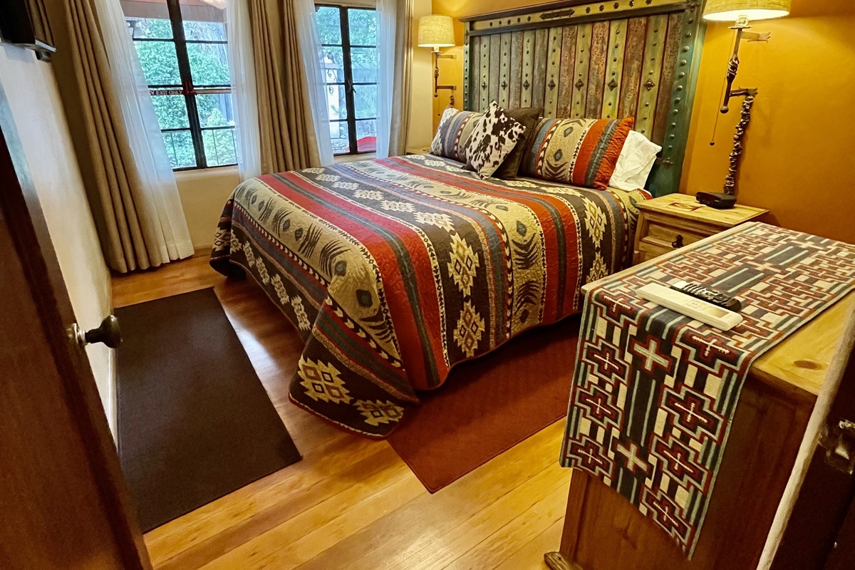 Wake up to garden views in this cozy king bed with southwestern charm.