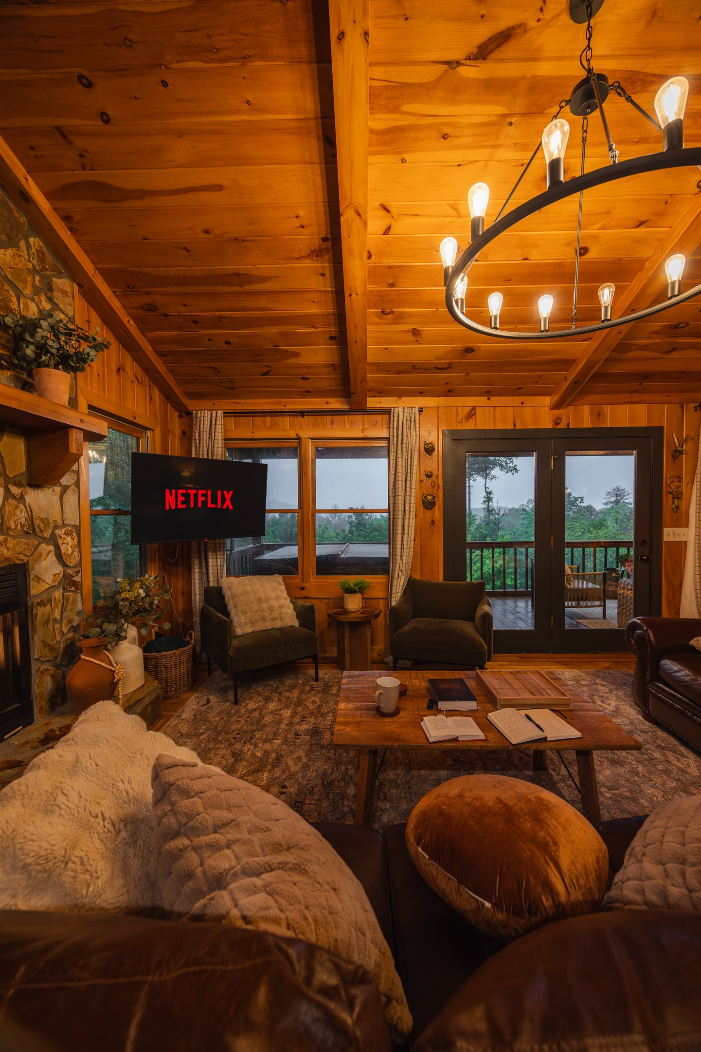 A warm, nostalgic living room wrapped in rich wood tones, with a Roku TV for easy entertainment inviting you to slow down, settle in, and feel at home in the mountains. 