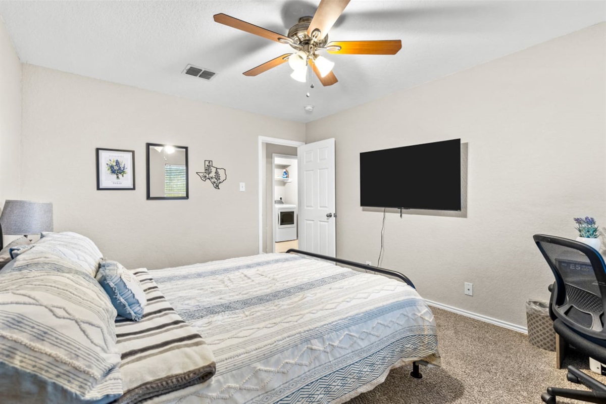 Comfortable queen room with plush bedding, blackout shades, streaming-enabled TV, and closet space—perfect for families or groups.