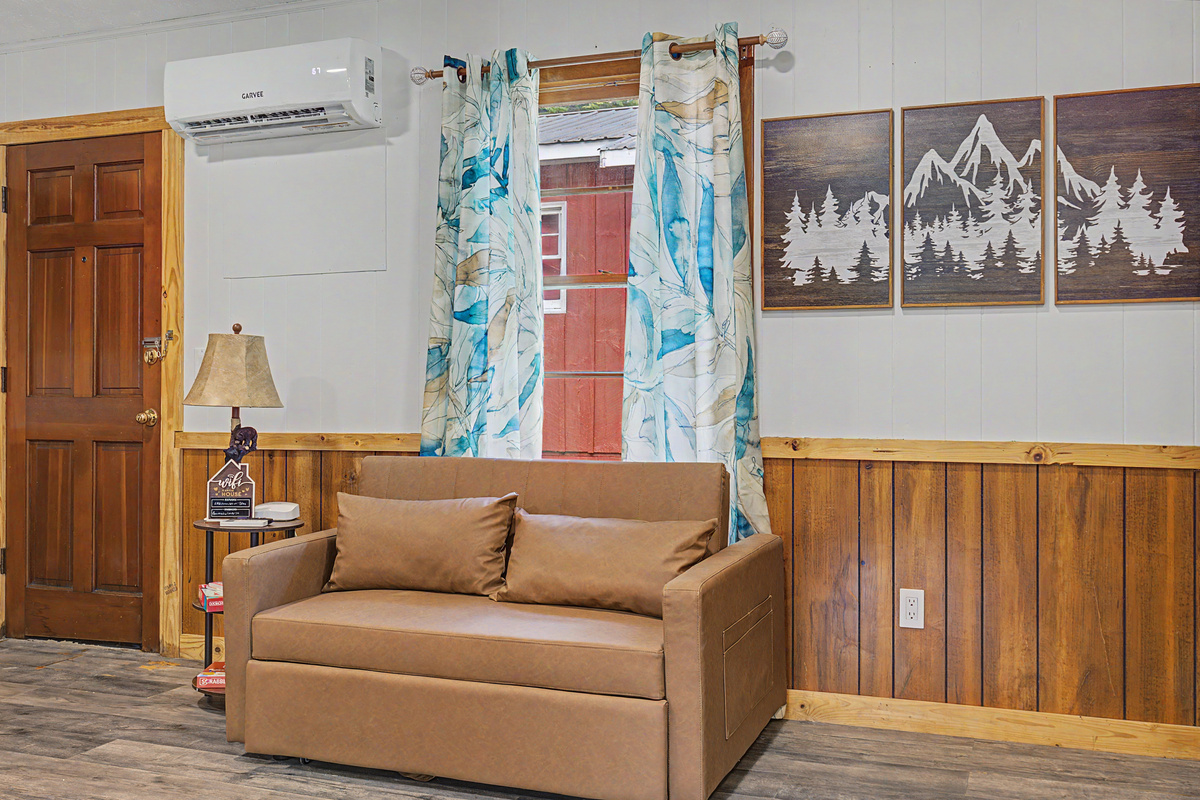 Living Room: Relax in style with mountain art, vibrant curtains, and inviting furniture!