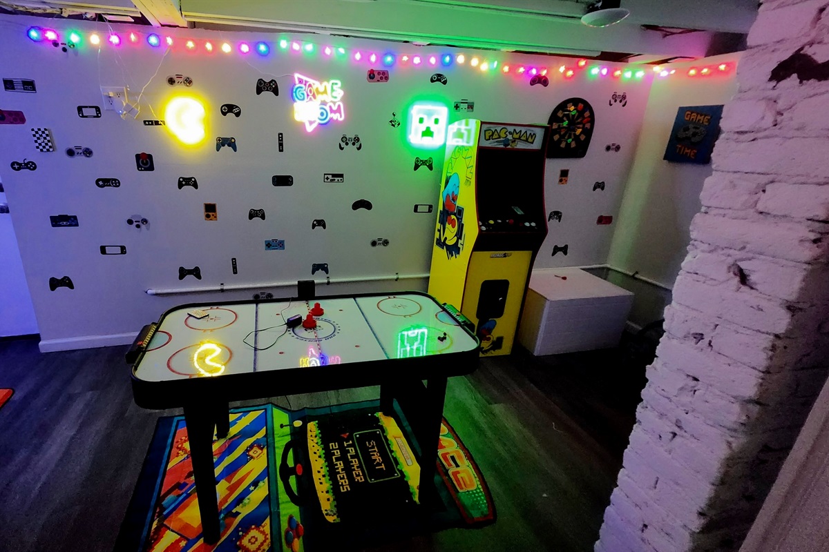 The game room is the place to be at Magic City Manor. We have it stacked with all the games you could dream! Even a life-size connect four game, a gaming desk, air hockey, darts, and a working pacman machine!