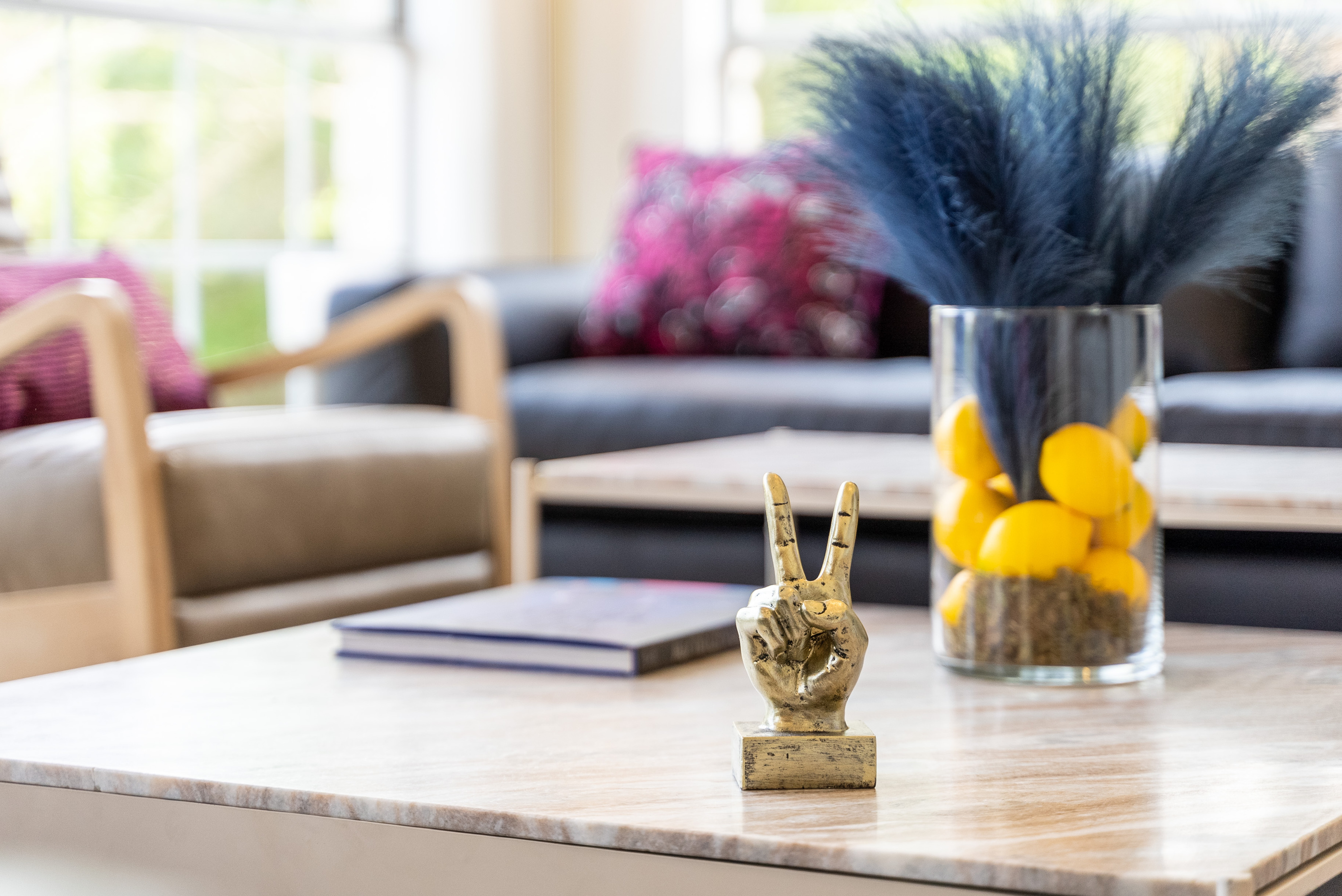 Curated coffee table styling with fresh florals and gold accents.