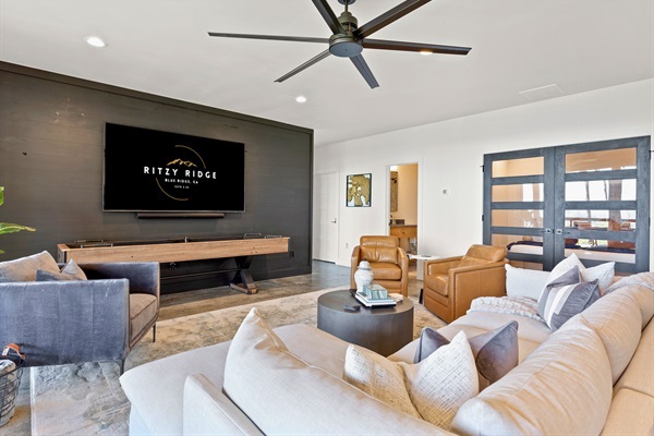 Modern entertainment meets rustic charm in this cozy living room, the perfect spot for movie nights and chill vibes.