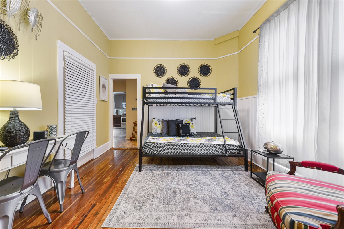 Bedroom 2. Downstairs. Bunk bed (1 full, 1 twin). Walkthrough from living to kitchen.