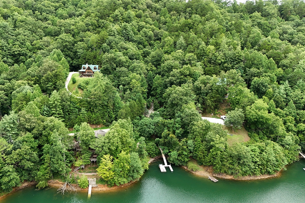 Exterior View: Nestled in lush greenery, this retreat offers stunning lake views and tranquility!