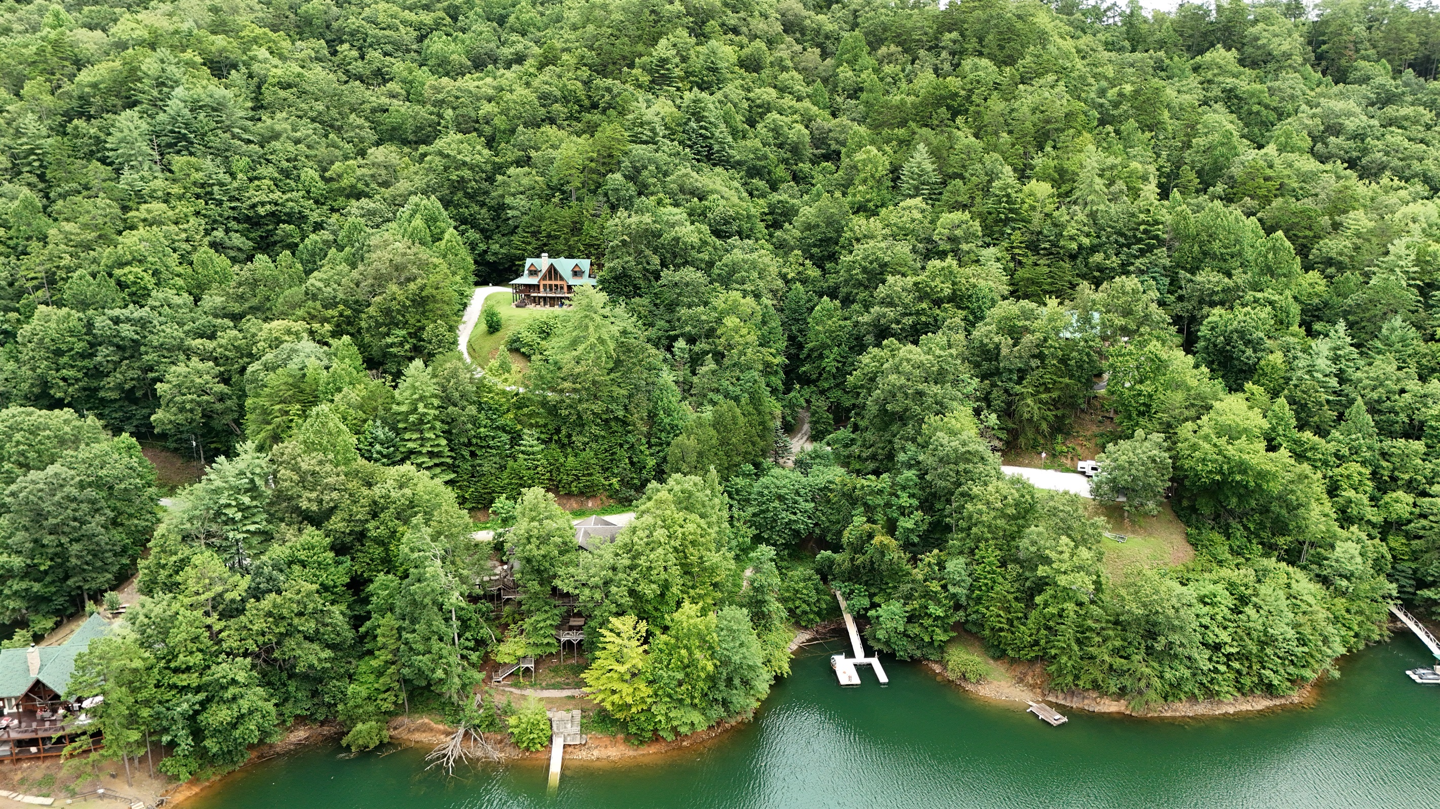 Exterior View: Nestled in lush greenery, this retreat offers stunning lake views and tranquility!