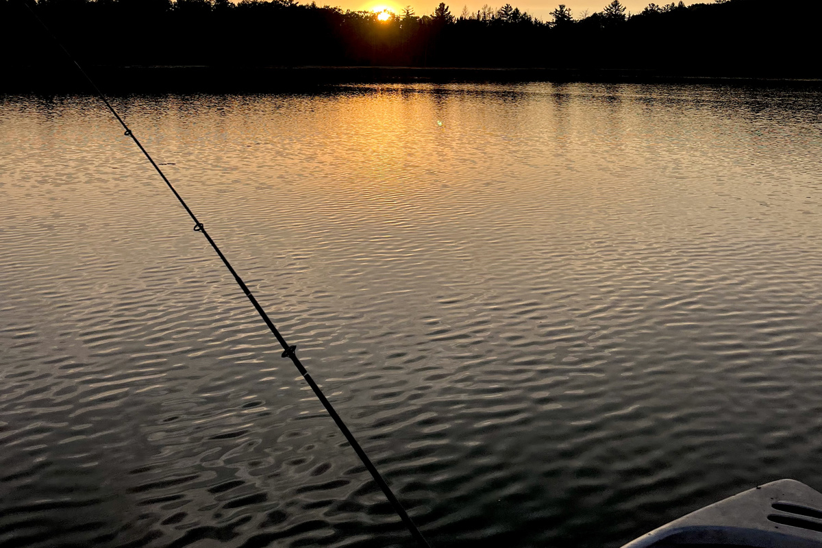 Fishing out on the boat at sunset.