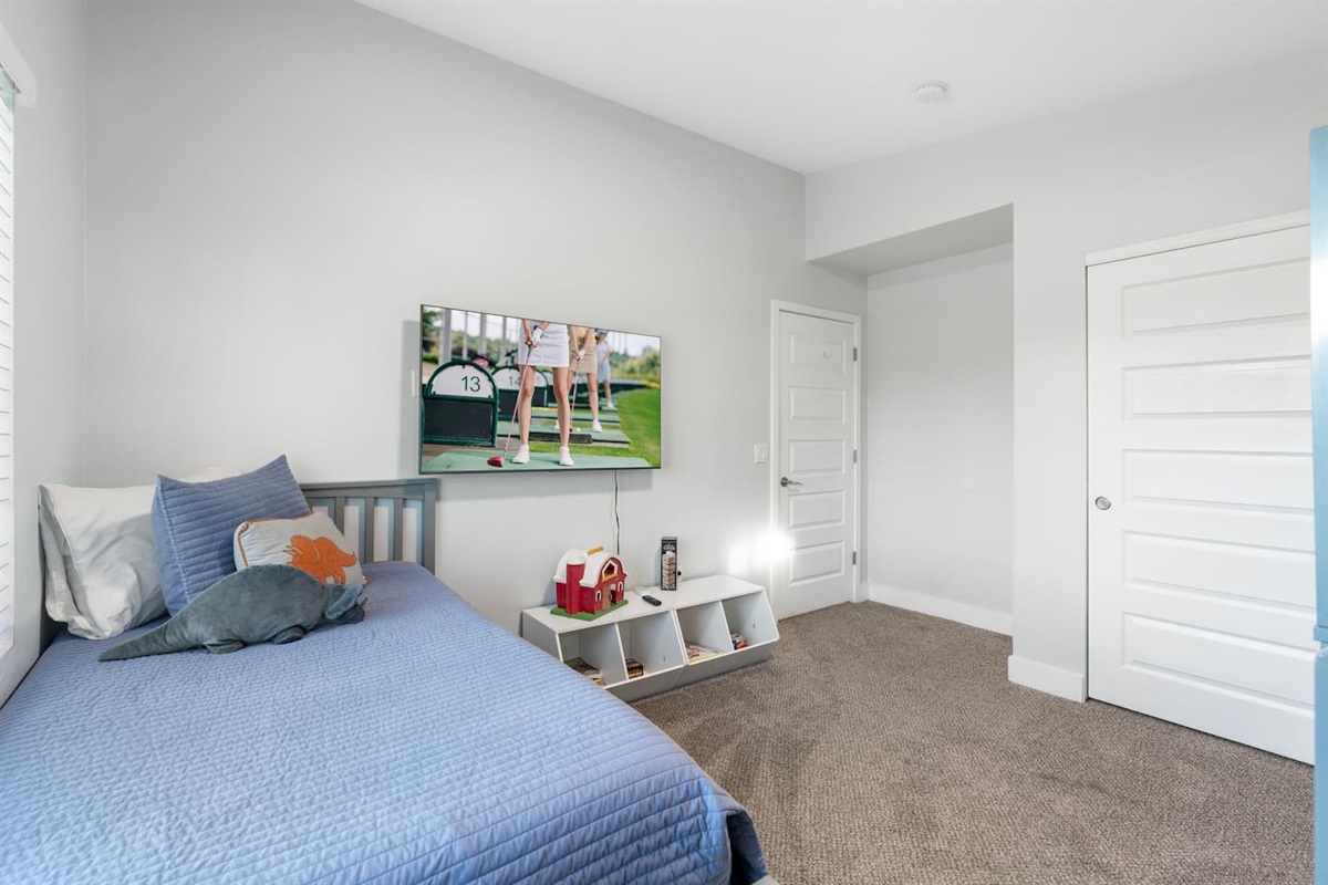 Cozy bedroom featuring a TV, perfect for relaxing and enjoying entertainment from the comfort of your bed.
