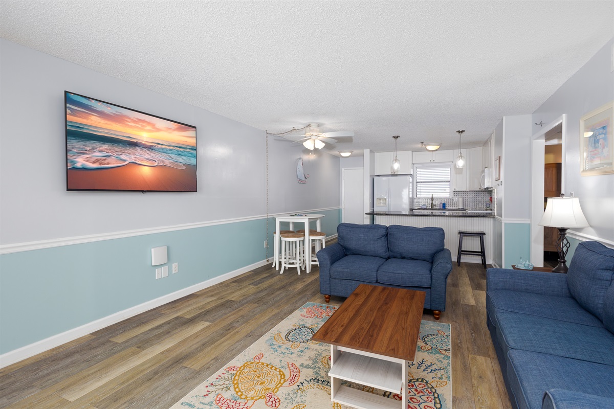 Open-concept living area with dining table and sofas