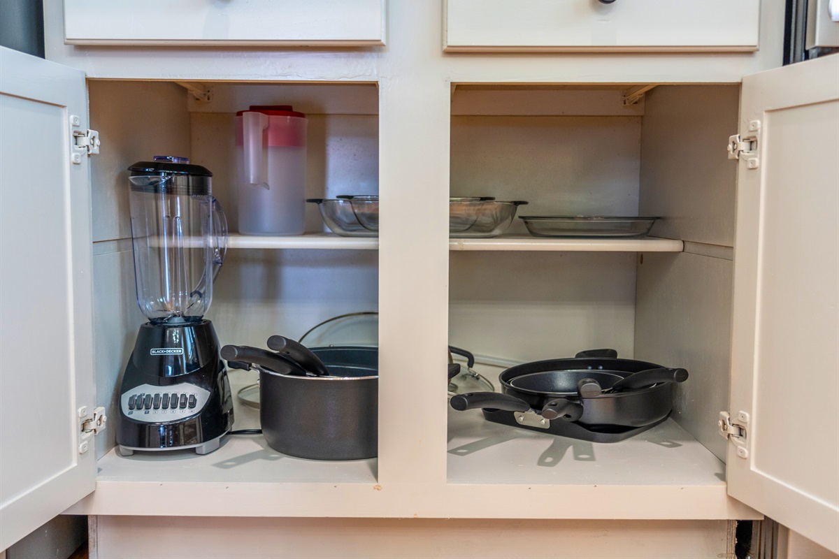 Organized storage featuring a blender and other kitchen tools is ready to help you with any culinary needs.