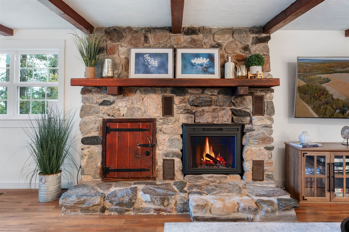 Enjoy the warm glow of the fireplace as you relax on the sectional sofa after a day sightseeing Leelanau County.