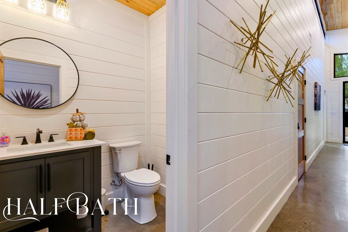 This charming half bath keeps things simple and stylish with thoughtful touches and modern accents.